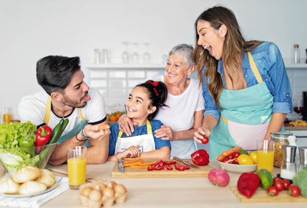 istock Happy family cooking together in a kitchen 1439953922