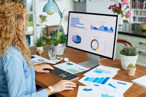 istock Businesswoman preparing financial charts on desktop PC 1439957199