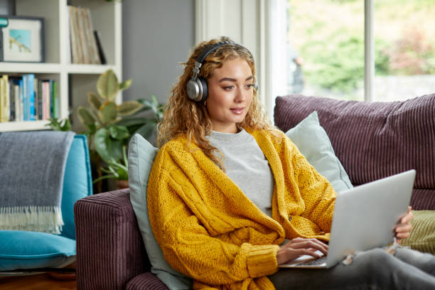istock Woman spending leisure time sitting on sofa 1439957665