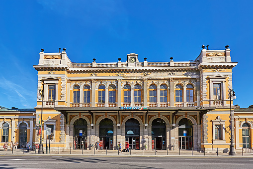 Trieste,  Italy - September 03, 2022: Pedestrians in front of the main train station in Trieste.