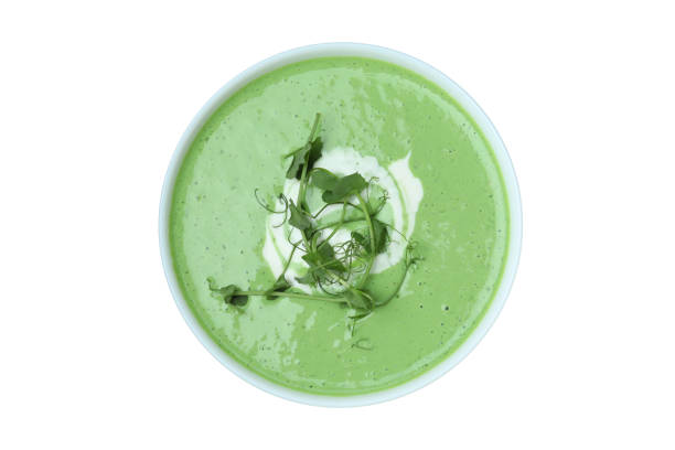 istock Plate of pea soup isolated on white background 1439958874