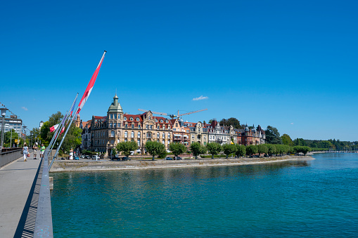Aerial view of historic Zurich city center with famous Grossmunster Church and river Limmat from Lindenhof park, Zurich, Switzerland. Summer landscape, sunshine weather, blue sky and sunny day