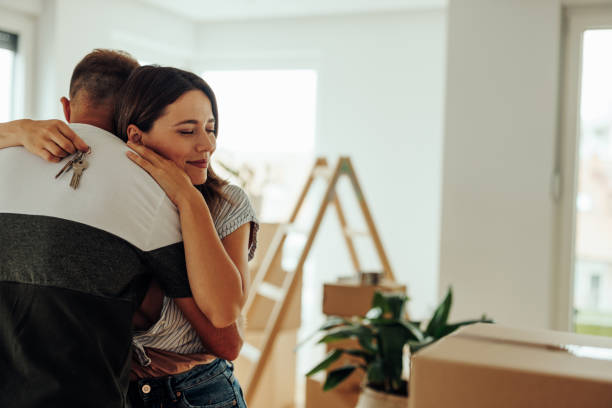 istock Couple hugging in new apartment. 1439961953