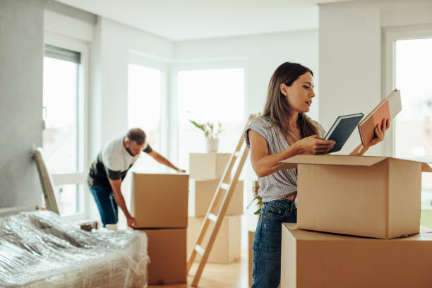 istock Caucasian couple unpacking in new home. 1439962088