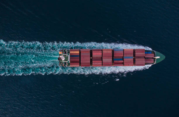 istock Aerial view of cargo container ship in the sea at night 1439962238