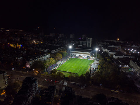 Aerial top view of a football match, soccer. Football field and Footballers from drone