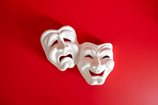 White color theater masks in red background