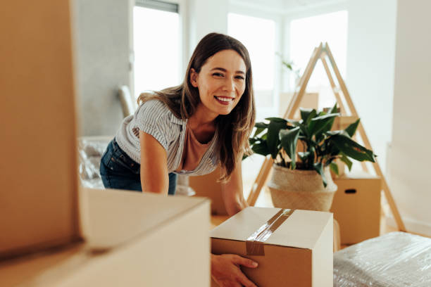 istock Caucasian woman moving into new home. 1439962462