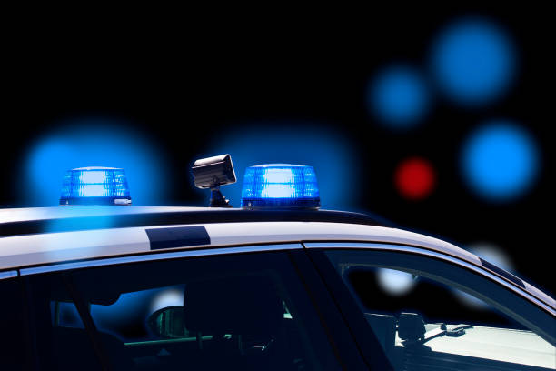 istock Police car at night with flashing lights 1439962504