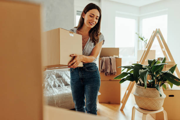 istock Cheerful woman moving in new home. 1439962507