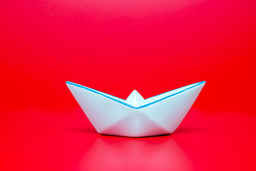 Ceramic boat on red background