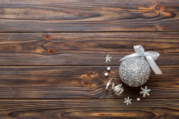 Christmas ball on colored background. decoration bauble with ribbon bow with copy space.