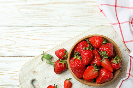 Concept of tasty eating with fresh strawberry on wooden table