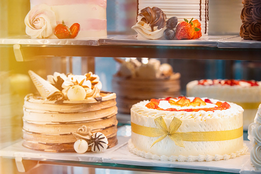 Small chocolate and vanilla layered cakes in rows on candy buffet. Sweet paradise.