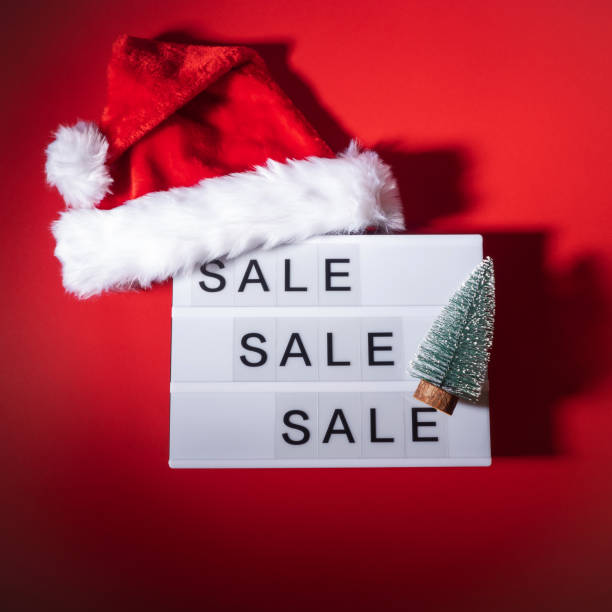 istock Christmas sale, boxing day lightbox on red with santa cap 1439965878