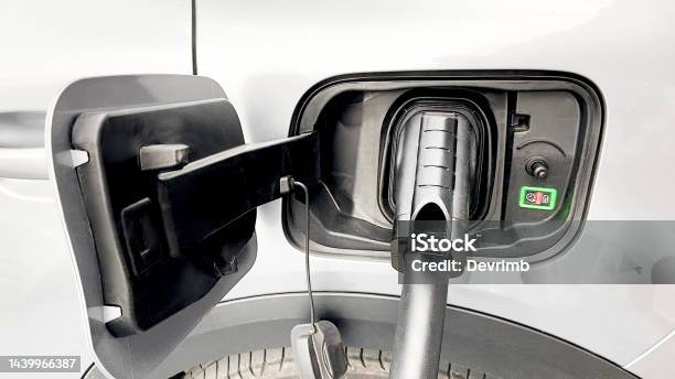 Electric Vehicle Charging Time Stock Photo - Download Image Now - Alternative Fuel Vehicle, Battery, Battery Charger