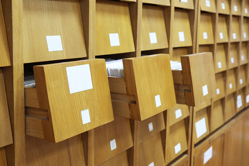 Here are ancient aged old vintage wooden drawers for archives documents files and folders.