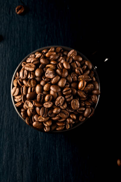 istock coffee beans in a cup on black background 1439969364