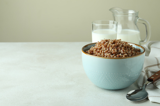 Concept of tasty eating with buckwheat on white textured table