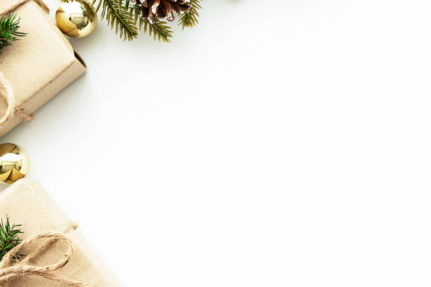 istock Beautiful Christmas background with two gift boxes, decorate with pine branch and pine cone over white background. Top view with copy space, flat lay. 1439970434