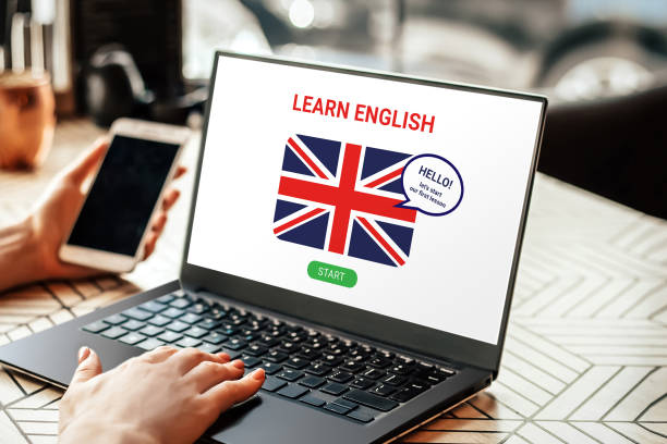 istock woman learning English online with laptop screen. Student using laptop doing online course on english 1439972002