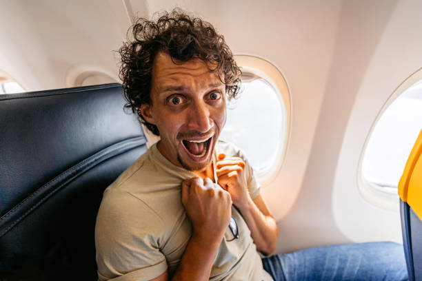 istock Male Passenger Having A Panic Attack In An Airplane 1439973402
