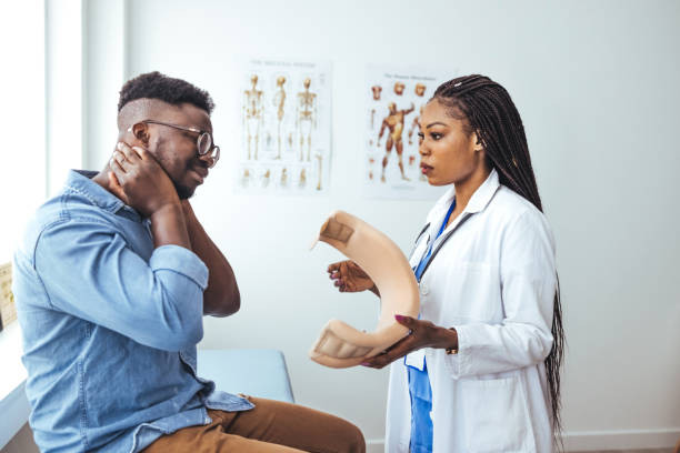 istock Man with cervical neck collar at doctor office, asking for help and being in pain 1439974221