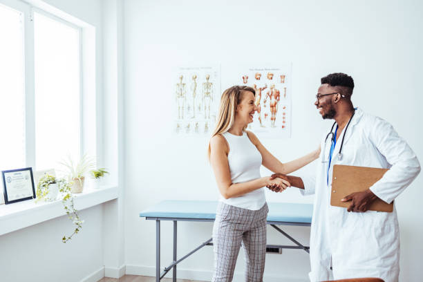 istock Doctor shaking hands with woman. 1439974861