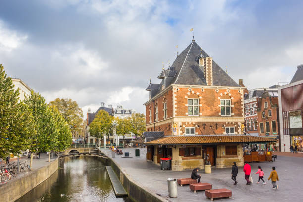 Historic Waag building at the central canal of Leeuwarden stock photo