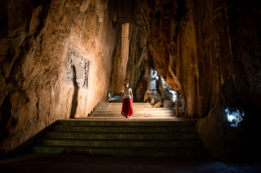 Tourist entering the Marble Mountains of Da Nang, Vietnam. Imposing Marble Mountains of Da Nang. Vietnamese landscapes. Young woman in Da Nang, Vietnam