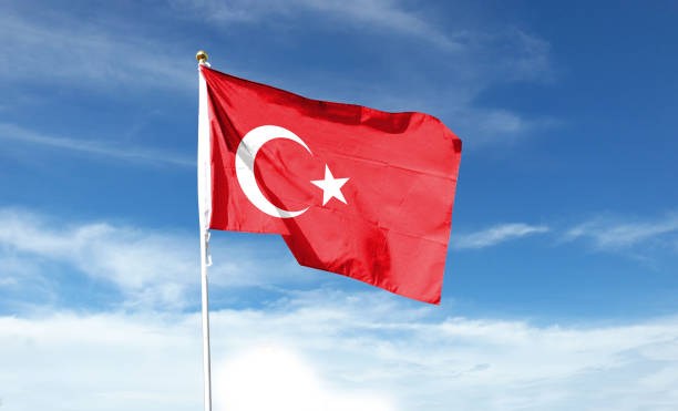 istock Turkish flag on cloudy sky. waving in the sky 1439975722