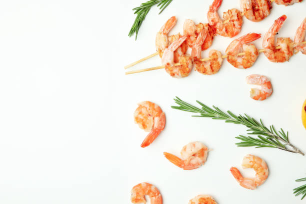 istock Tasty grilled shrimps and ingredients on white background 1439976485