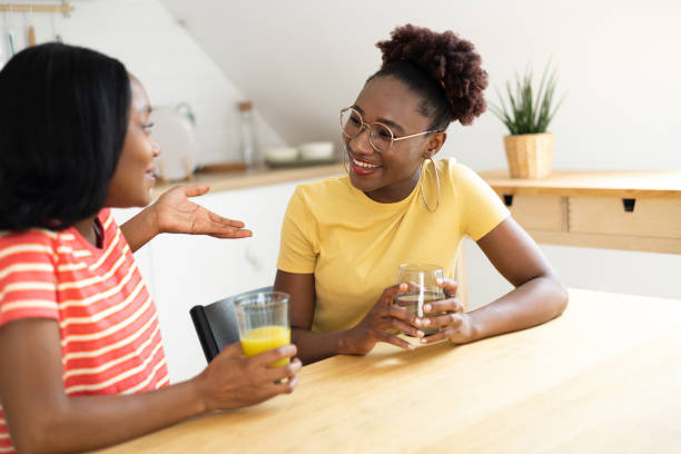 istock Two African American roommates refreshing and gossiping in the kitchen 1439977252
