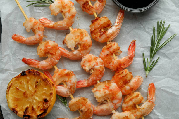 istock Tasty grilled shrimps on rustic wooden background 1439977284