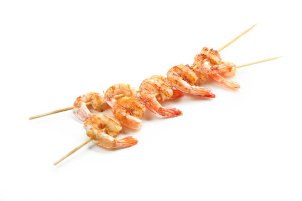 istock Tasty grilled shrimps isolated on white background 1439977495