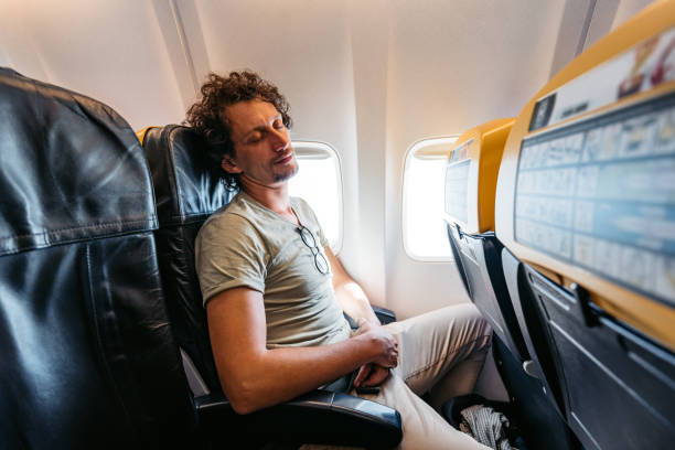 istock Young Man Sleeping In An Airplane 1439979479