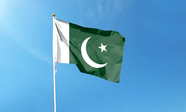 istock Pakistan flag on cloudy sky. waving in the sky 1439979637