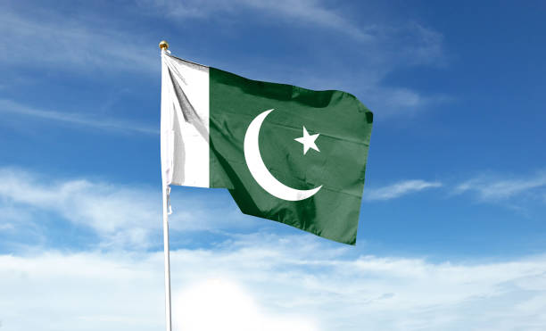 istock Pakistan flag on cloudy sky. waving in the sky 1439979681