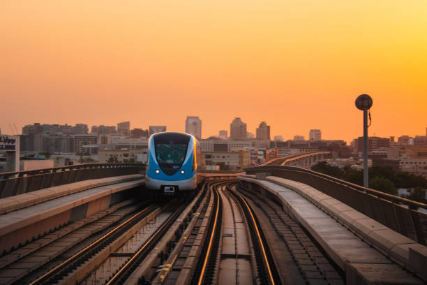 istock Dubai, UAE - 10th october, 2022: metro train on railway in Dubai with sunset orange sky background 1439980213