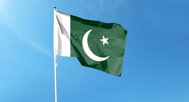 istock Pakistan flag on cloudy sky. waving in the sky 1439980341