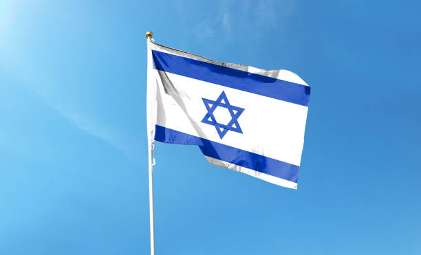 istock Israel flag on cloudy sky. waving in the sky 1439982729