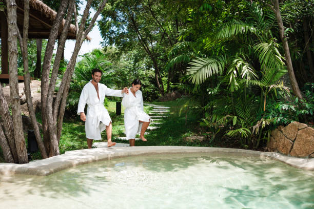 Couple entering refreshing pool after sauna
