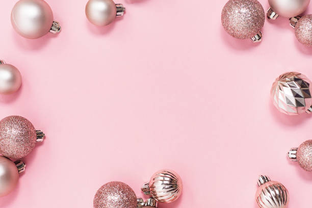 istock Decorative pink shiny balls, place for text on a pink background. Top view, flat lay. 1439984709