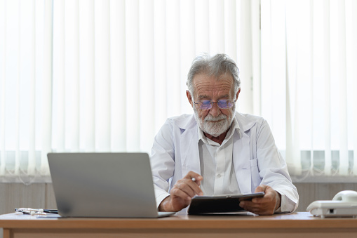 Senior doctor wears headset. Remote online medical chat consultation, tele medicine distance services. Telehealth concept