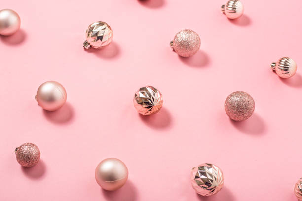 istock Background with beautiful shiny pink decorative balls on a pink background. Top view, flat lay. 1439985807