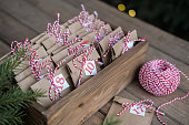 Preparing for Christmas. Christmas advent calendar. Eco paper craft bags with small gifts in a wooden box. Eco-friendly style. Eco-friendly Christmas