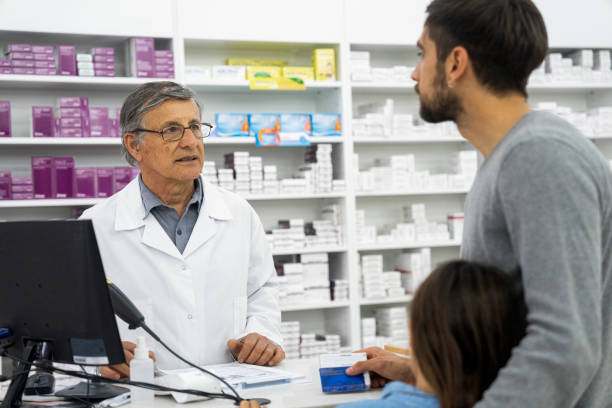 istock A middle-aged pharmacist assists a man at the pharmacy counter 1439989274