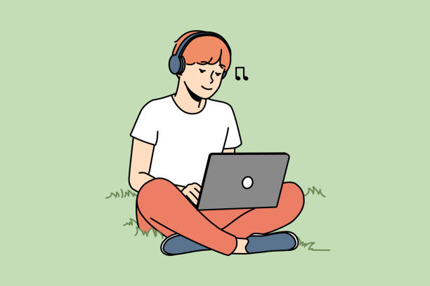Guy sitting on grass with laptop and headphones vector art illustration