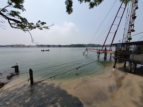 Fort Kochi coastal area in Kerala India where fishermen use ancient Chinese fishing nets to catch fish