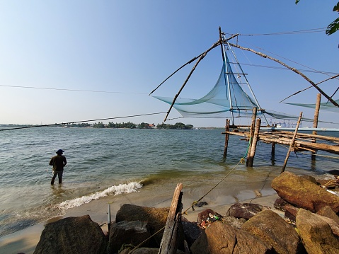 Fort Kochi coastal area in Kerala India where fishermen use ancient Chinese fishing nets to catch fish